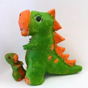 Dad & bub dinosaurs in clay painted green with orange on scales, dots & nose