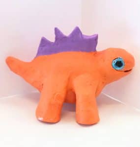clay sculpture of a dinosaur orange & purple
