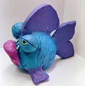 funny fish scullpture in clay painted pink, purple & blue